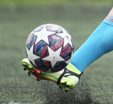 close-up of a player hitting a soccer ball